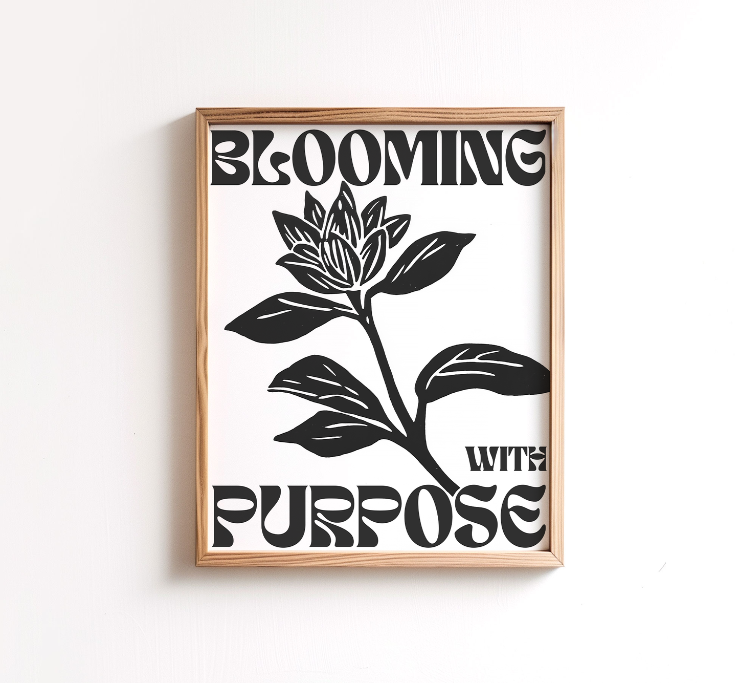 Christian wall art featuring a minimalist black and white floral design with the words blooming with purpose framed in wood modern Christian home decor