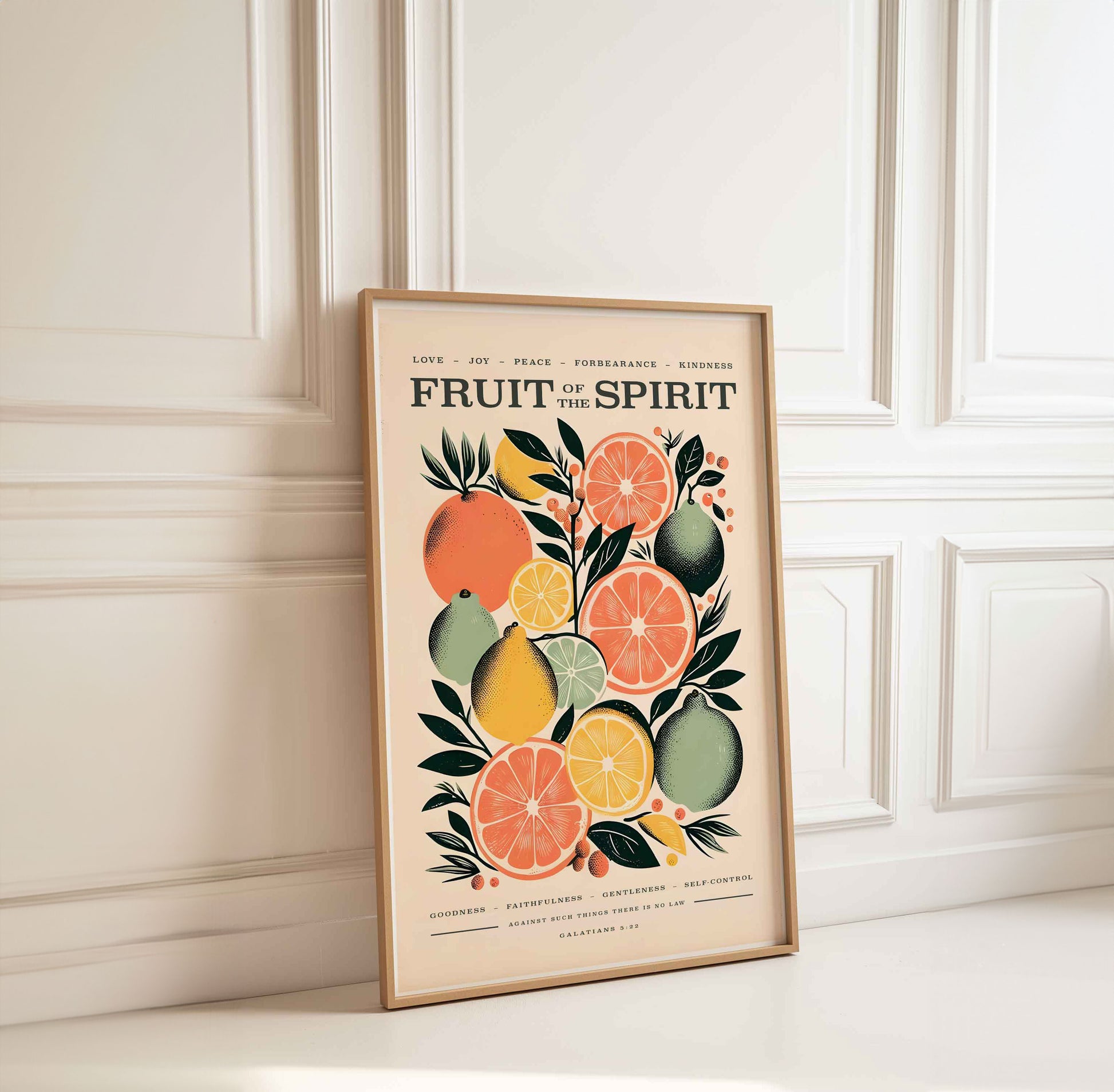 Framed Fruit of the Spirit Bible verse wall art print with citrus fruit design leaning against an elegant white wall Christian decor featuring Galatians 5:22 modern minimalist faith-based artwork Modern christian wall art print scripture art