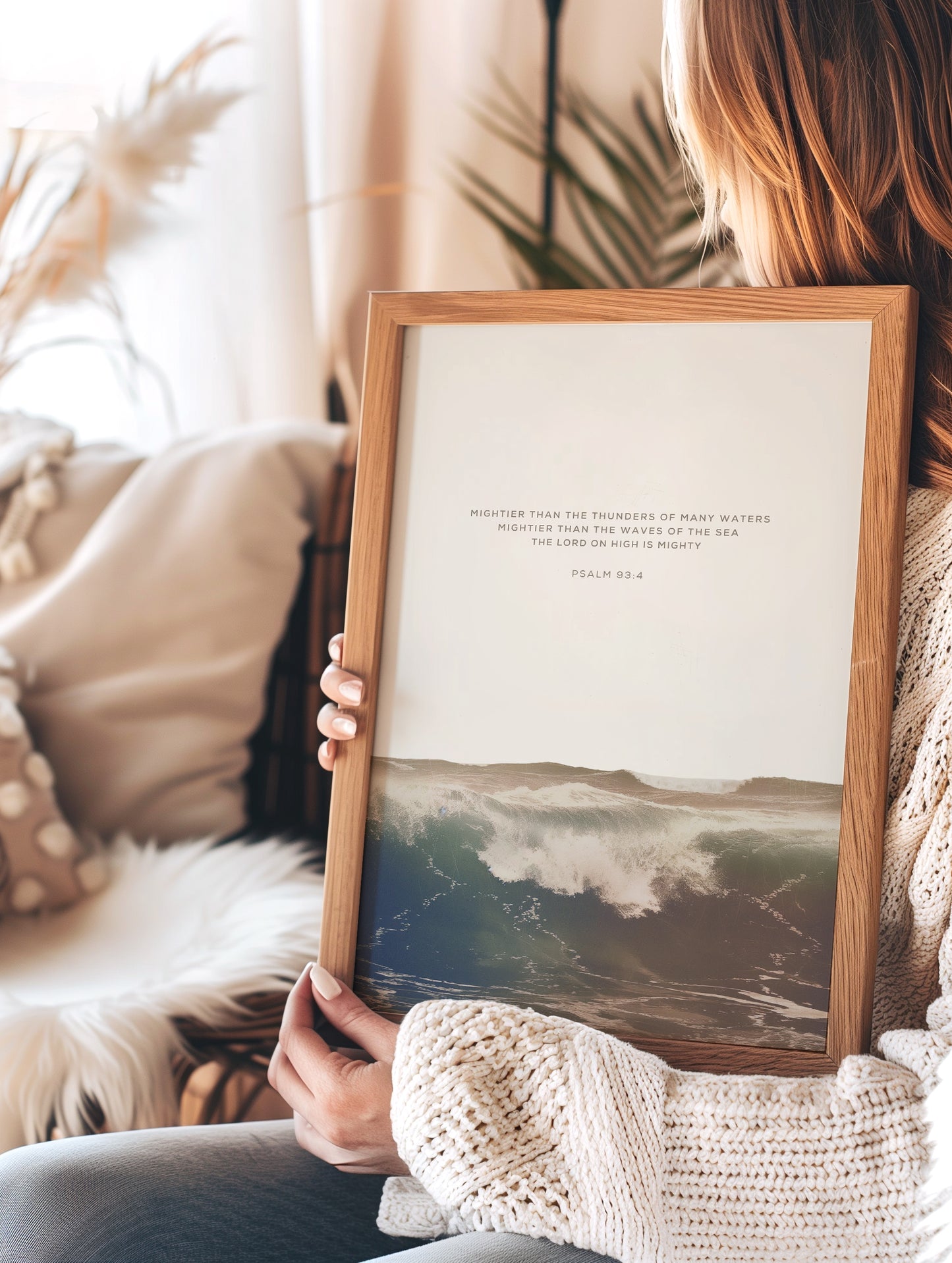 Woman holding framed Psalm 93:4 Mighty Waters art, highlighting ocean waves and scripture for serene, faith-based decor.